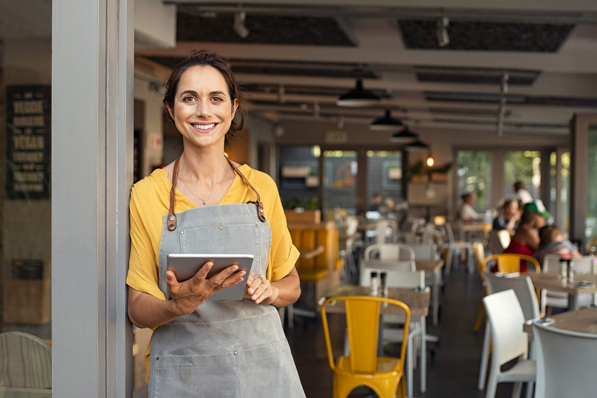 Woman welcoming restaurant guests